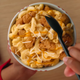 hand over mac and cheese bowl